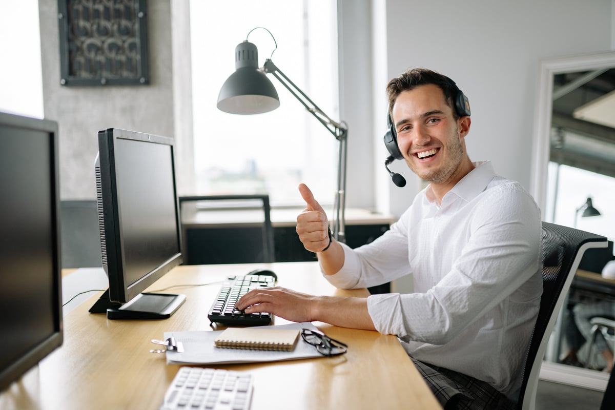  A Man Working in an Office while Wearing a Headset